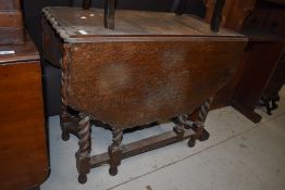 An early 20th Century oak twist gateleg dining table having piecrust style top