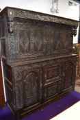 A Period oak court cupboard of large proportions, heavy carving/pokerwork decoration, width
