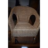 A pair of wicker conservatory or similar chairs
