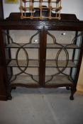 An early 20th Century mahogany bookcase/display cabinet having ball and claw feet