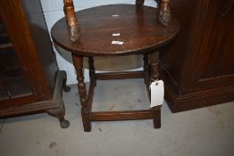 A traditional oak coffee table having circular top, diameter approx. 50cm