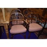 A lovely Harlequin matched set of four Elm Windsor armchairs, having turned legs, crinoline