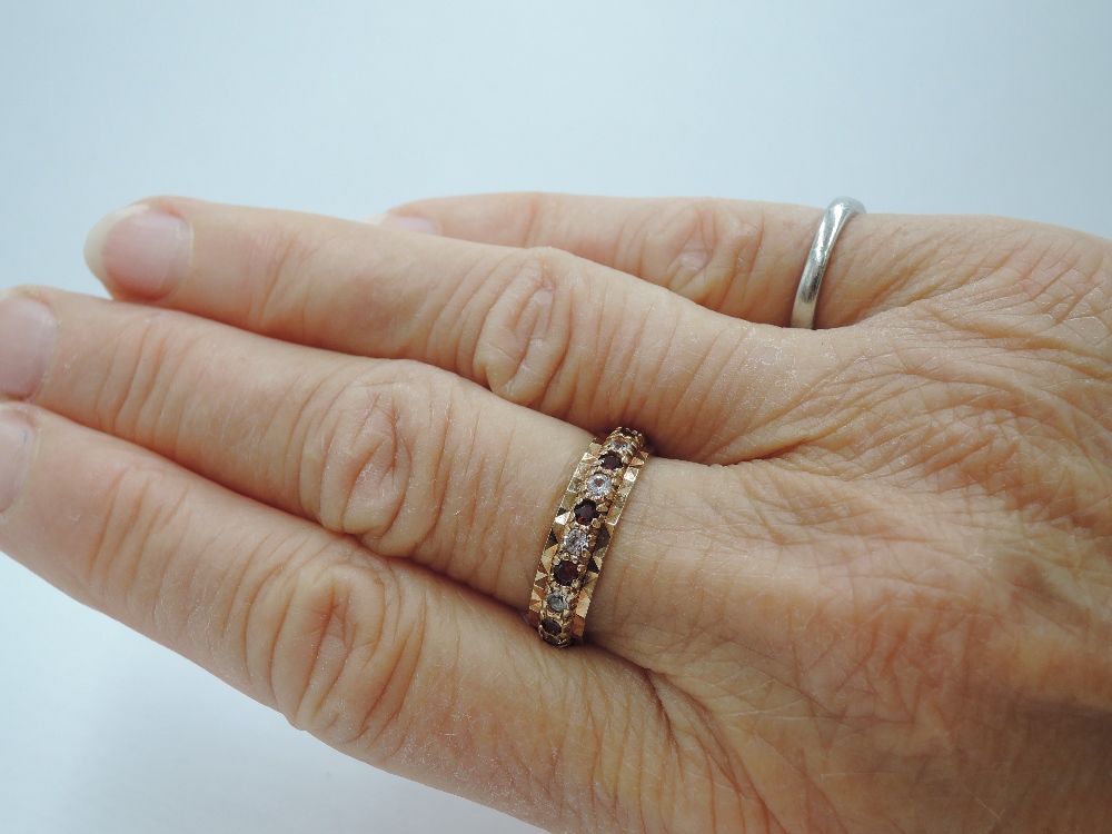 A 9ct gold full eternity ring set with garnet and cubic zirconia in a cut mount, size P & 3.7g - Image 2 of 2