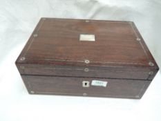 A vintage wooden stationery box having mother of pearl decoration containing a selection of