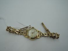 A vintage rolled gold wrist watch by Cyma having a baton numeral dial to small circular face on a