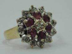 A ruby and diamond chip cluster ring having an illusionary set mount on a 9ct gold loop, size S &