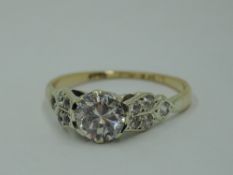 A cubic zirconia solitaire dress ring having set shoulders to a 9ct gold loop, size O & approx 2.2g