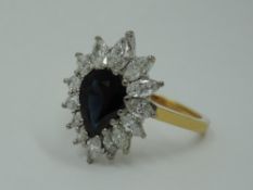 A sapphire and diamond teardrop cluster dress ring having graduated marquise cut diamonds, total