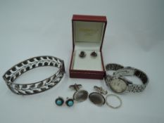 A small selection of silver and white metal jewellery including two pairs of stud earrings, a band