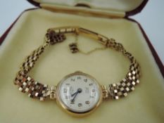 A lady's 9ct gold Rotary wrist watch having Arabic numeral dial to champagne face in a 9ct gold case