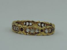 An 18ct gold eternity ring of shaped form having paste stones, size O & approx 3.4g