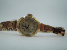 A lady's 9ct gold gold Roamer wrist watch having an Arabic numeral dial to small face in gold case