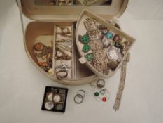 A cream material jewellery box containing a selection of rolled gold and white metal jewellery