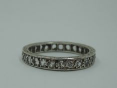 A white metal and paste full eternity ring stamped SIL, size O