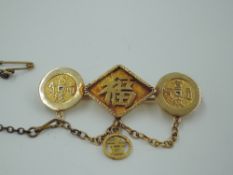 A Far Eastern yellow metal brooch stamped 18 having three panels bearing lettering, makers mark WN