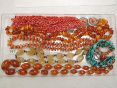 A small selection of strings of beads including Baltic amber, Cornelian, polished stone,