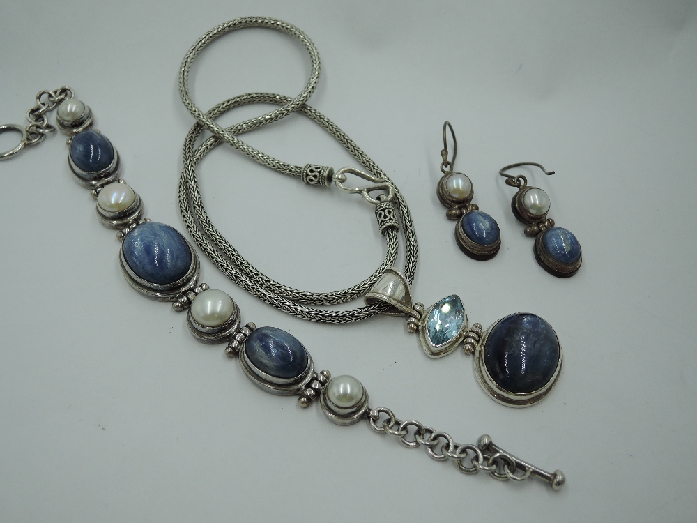 A silver three piece artisan style set comprising necklace, bracelet & earrings having blue - Image 2 of 2