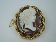 A large Victorian conch shell cameo brooch having a spinning central cameo depicting Dionysus (god