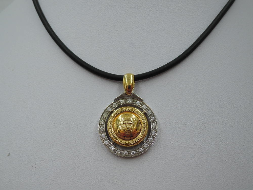 A white and yellow metal Versace Medusa style pendant necklace stamped 750 having the central Medusa