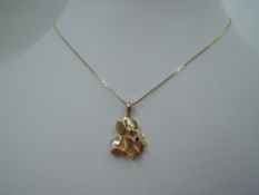 An American gold nugget pendant stamped 14K on a fine yellow metal chain stamped 14k, approx 27' &