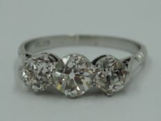 A lady's three stone old cut diamond trilogy ring, total approx 1.75ct in a claw set basket mount on