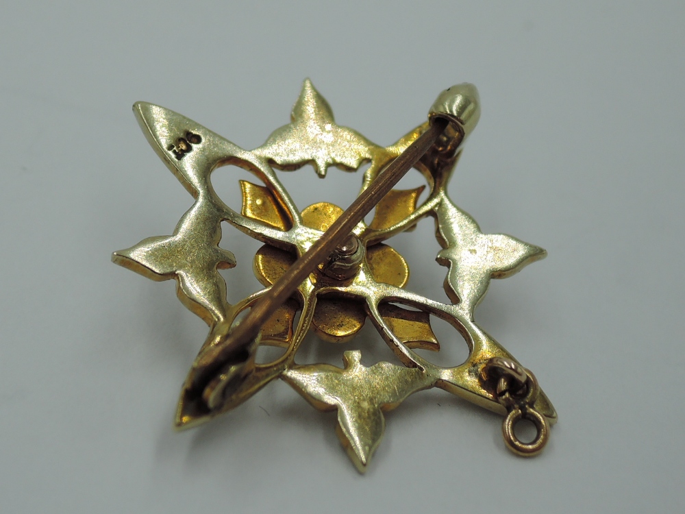 An Edwardian yellow metal brooch stamped 9ct in an open star form having seed pearl decoration, - Image 2 of 2