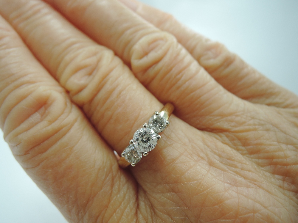 A diamond trilogy dress ring, total approx 1ct in a claw set stepped mount on a yellow metal loop - Image 3 of 4