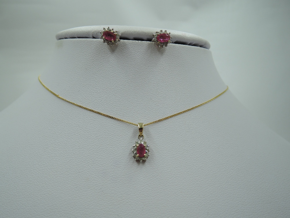 A ruby and diamond chip cluster 9ct gold pendant and matching earrings, approx 18' & 2.4g
