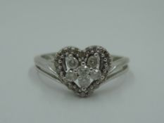 A diamond heart cluster dress ring having open shoulders on a 9ct white gold loop, size O & 2.5g