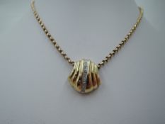 An American 14ct gold scallop shell pendant of moulded form having diamond chip decoration on a 14ct