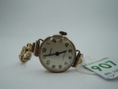 A lady's 9ct gold wrist watch by Ingersoll having Arabic numeral dial to white face in a gold case