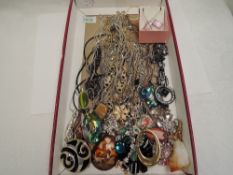 A large selection of costume jewellery pendants including glass, enamelled, etc