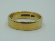 An 18ct gold wedding band bearing inscription to inside, size O & 5.2g