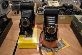 Two folding cameras. A Ziess Ikon and a Kodak Folding Brownie Six-20
