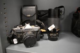 A Fujica STX-1n camera with 50mm lens and a Tamron 80-210mm zoom lens in a soft camera bag