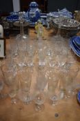 A mixed lot of vintage and antique glasses and decanters including etched examples and cut glass.