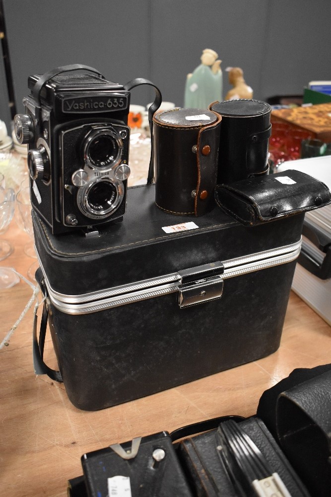 A Yashica 635 reflex camera in hard case with wide angle lens and tele photo lens