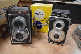 Two Reflex cameras. A Ricohflex Model III and a Halina Perfect in its original box