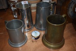 A selection of pewter mugs and tankards.