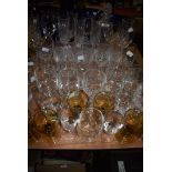 A large assortment of vintage and retro glasses and a decanter, various styles and sizes including