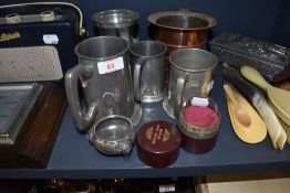 Four pewter tankards or mugs and a similar copper and pewter lined copper creamer