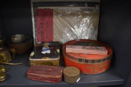 A selection of vintage advertising containers including Mackintosh Carnival biscuit tin