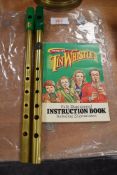 Two musical tin whistles and an instruction book