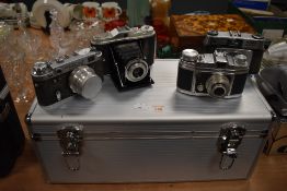 Four 35mm cameras including an Agfa Isolette, an Ilford Sportsman, a Saraber Finetta 88 and QED-2 in