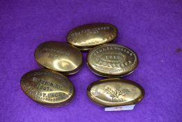 Five brass cast snuff or pill case including Crosskeys and Station road