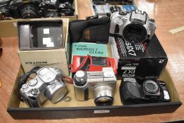 A selection of cameras including Canon EOS IX7, a Canon Powershot S1 IS, and Olympus Zoom 2000, an