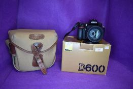 A Nikon camera body in original box with instruction book and memory cards, a Nikon AF-S Nikkor 18-