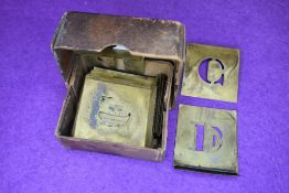 A printers or similar stencil letter type set in brass plate