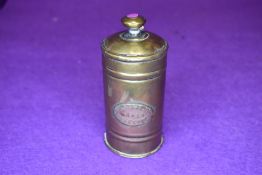 A brass container possibly chemist related having lid