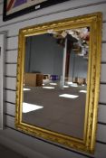 A large gilt framed mirror.